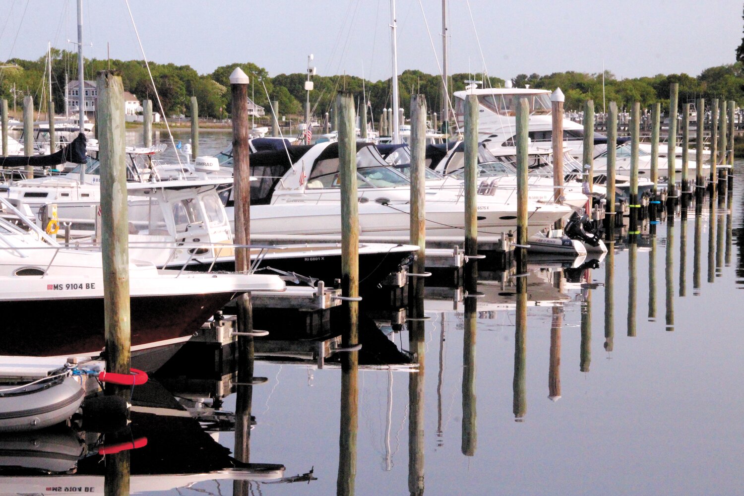 MORNING REFLECTIONS: Pilings and the more than 200 boats berthed at the Harbor Lights marina are reflected in the still waters of Warwick Cove.