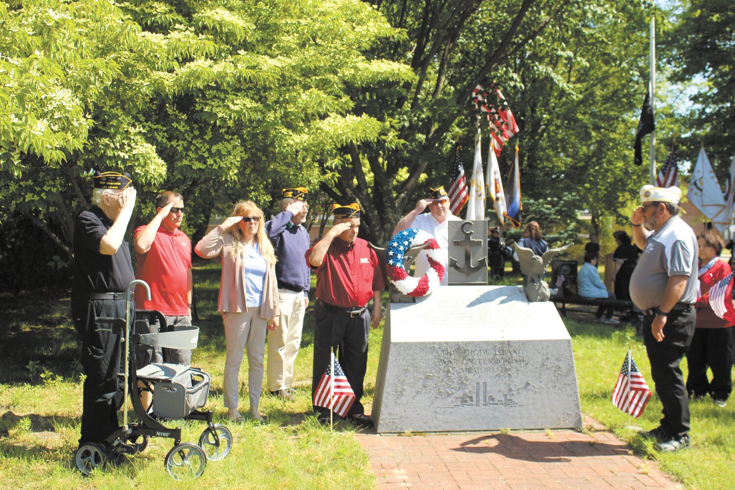 PLACING OF THE WREATH: Members of Chapter 9 of the Rhode Island Disabled American War Veterans placed a wreath on the stone at the entrance to Veterans Park on West Shore Road.