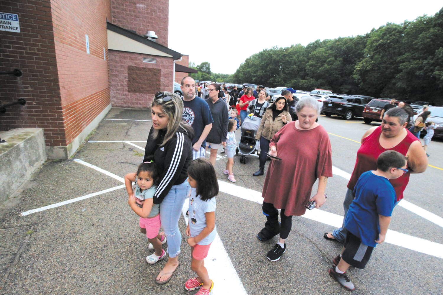 READY TO SEE IT: Students and parents line up to visit classrooms in Gorton where Oakland Beach will be operating starting Tuesday