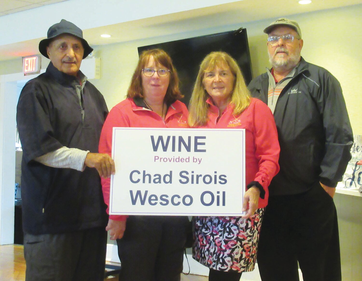 OUTSTANDING ORGANIZERS: The LaFazias – Vin and Linda – and the Graham’s – Judy and David – are holding a sign for the Chad Sirois Wesco Oil wine sponsors. (Sun Rise photo by Pete Fontaine)