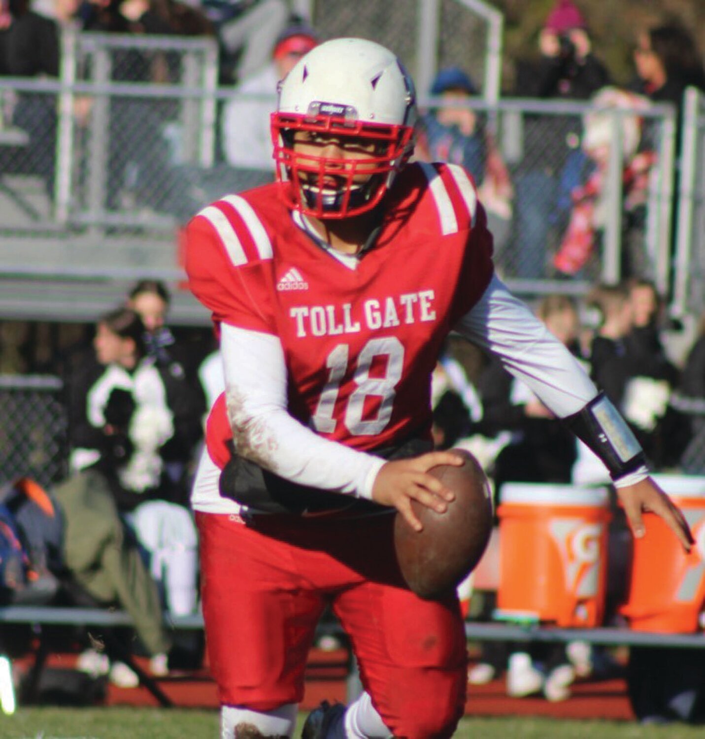 ROLLING OUT: Toll Gate quarterback Jayden Pina rolls out to pass in the first quarter of the Beacon Bowl last week.